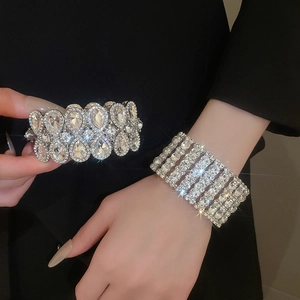 Detailed close-up of a luxury silver-tone elastic bracelet with pear-cut and round crystals