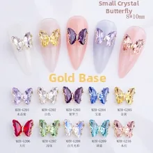 Macro detail of 8x10mm crystal butterfly nail charms with gold metal base in 10 colors
