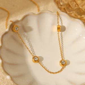 18K gold plated stainless steel necklace with round zircon in a white shell dish