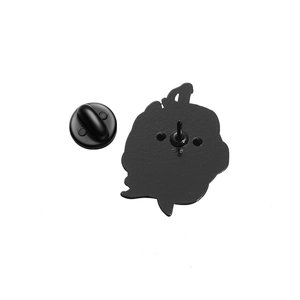 Detailed back view of a black metal badge with dual pins and a rubber clutch back