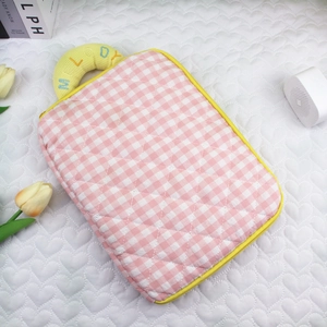 Detailed embroidery of Melody text on the yellow handle of a pink quilted iPad sleeve