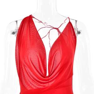 Detail of red sleeveless cowl neck dress with elegant draping on a white mannequin