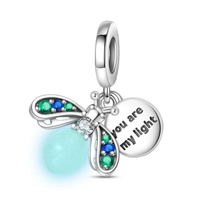 Detailed view of silver firefly charm with blue luminous bead and engraved tag