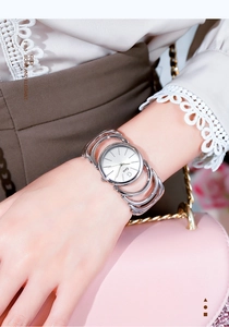 Close-up of Gedi silver mesh bracelet watch on woman's wrist with minimalist round dial