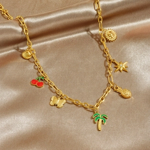 Gold plated necklace with enamel tropical charms including cherry, palm tree and butterfly