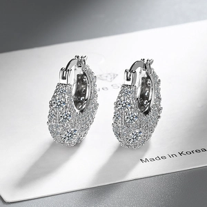 Macro shot of 925 silver hoop earrings with micro-paved sparkling cubic zirconia stones