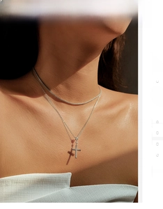 Detail view of layered S925 silver necklace with sparkling cross pendant and tennis chain