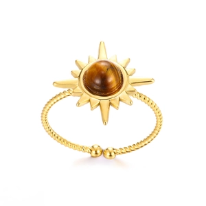 Macro detail of sunburst boho ring with round tiger eye stone on gold rope band