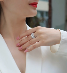 Detailed view of luxury 925 silver wide multi-row moissanite ring worn by a model