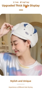 Close-up of thick coral fleece hair towel with cute blue ears and a purple button