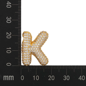 Macro shot of gold-plated letter K pendant with cubic zirconia and size measurements