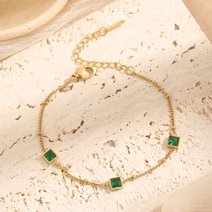Gold-plated stainless steel bracelet featuring three green square-cut zircons and lobster clasp