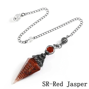 Macro shot of Red Jasper energy pendulum with antique silver cap and metal chain detail
