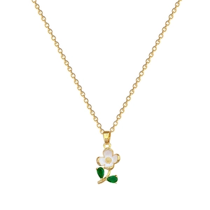 Luxurious gold flower pendant necklace with white petals and green leaves on white backdrop