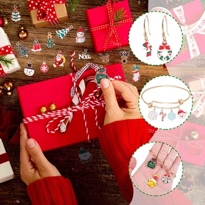 Christmas jewelry set featuring enamel Santa, tree, and reindeer charms in festive packaging