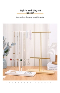 Modern white metal jewelry stand with wooden base displaying earrings and necklaces