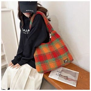 Close-up of colorful checkered faux shearling tote bag showing texture and large capacity