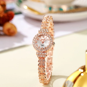 Detail shot of rose gold women watch with rhinestone bezel and quartz movement dial