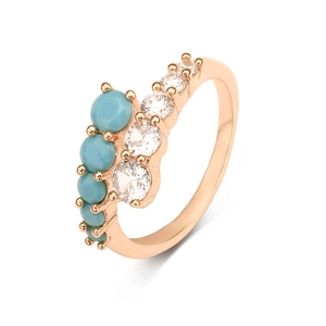 Rose gold ring with turquoise stones and shimmering cubic zirconia in elegant open design