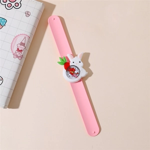 Detail of pink silicone slap watch featuring a 3D white cartoon rabbit and carrot
