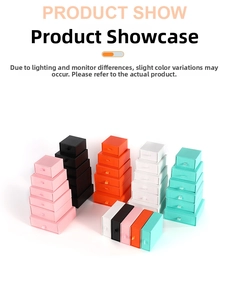 Stack of colorful drawer gift boxes with ribbon handles in various sizes and colors