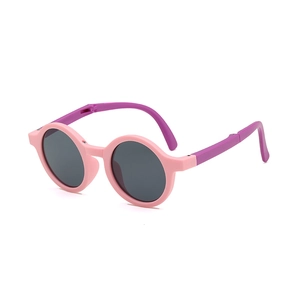 Foldable kids round sunglasses with pink frame and purple temples shown in a side view