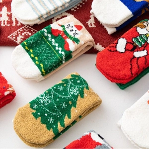 Plush Christmas socks set featuring warm coral fleece with festive snowman and tree patterns