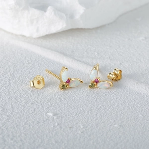 Macro detail of S925 silver gold-plated stud earrings with marquise opal and zircon