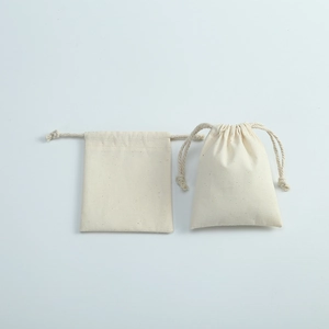 Detail of natural beige cotton linen drawstring bag showing fabric texture and closure