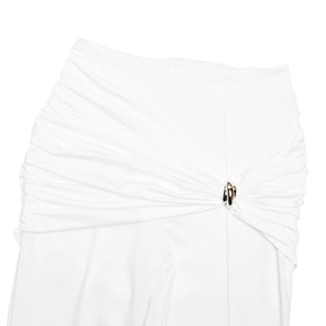 Detail of white trousers with pleated design and metal ring buckle on smooth fabric