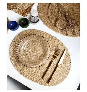 Macro detail of natural jute woven placemats in round and oval shapes for heat resistance
