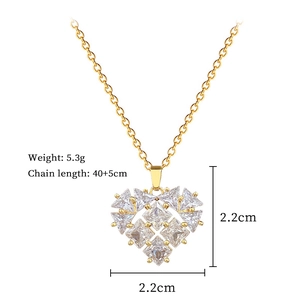 Detailed view of a gold hollow heart pendant with sparkling cubic zirconia crystals