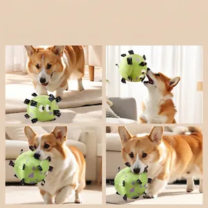 Green plush interactive dog soccer ball with woven straps and built-in bell for training