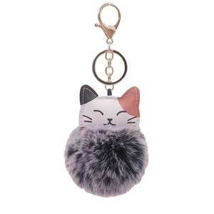 Cute plush cat keychain with a grey pompom and gold metal ring on a white background