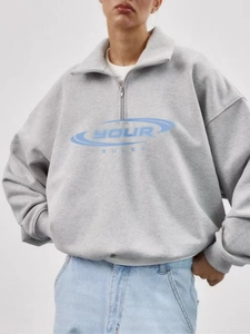 Grey half-zip sweatshirt with YOUR RULES letter print shown on model in a studio shot