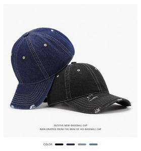 Detailed macro shot of vintage washed denim baseball caps with distressed ripped edges