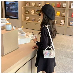 Girl's white plush crossbody bag featuring pearl handle and cute rabbit doll ornament