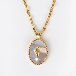 Detailed macro view of vintage gold necklace with pearl shell tulip pendant and bead edge