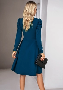 Rear view of an elegant navy blue long-sleeve dress with puff sleeves and waist cinching