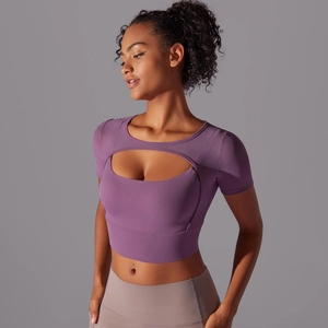 Detail view of purple short sleeve yoga top featuring front cut-out design and slim fit