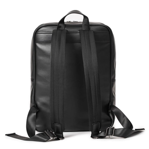 Detail view of woven leather backpack showing padded straps and metallic adjustment buckles