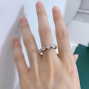 Close-up of sparkling pear-cut diamonds set on a polished silver band on hand