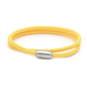 Detail of bright yellow double-wrap braided cord necklace with magnetic metal clasp closure
