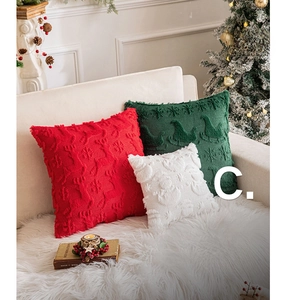 Detail of festive embroidered Christmas pillow covers with reindeer and snowflake motifs