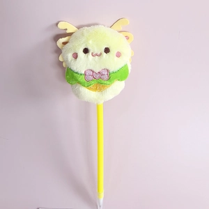 Detailed view of yellow plush monster ballpoint pen with soft fur and pink bow
