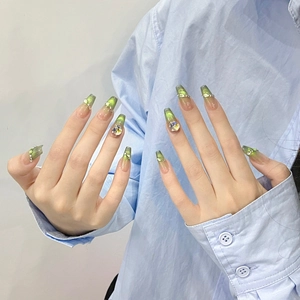 Handmade green cat-eye press-on nails with luxury crystals and translucent gradient