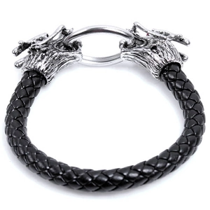 Detail of black braided leather bracelet featuring silver metal dragon head clasps