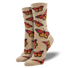 Close-up of beige crew socks featuring detailed orange and black butterfly patterns