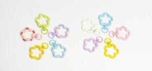Colorful flower-shaped spring rings and swivel clasps in assorted pastel shades