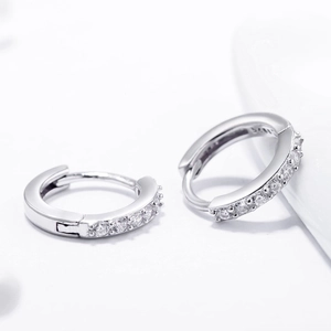 Classic S925 sterling silver huggie earrings with sparkling CZ pavé stones on white background